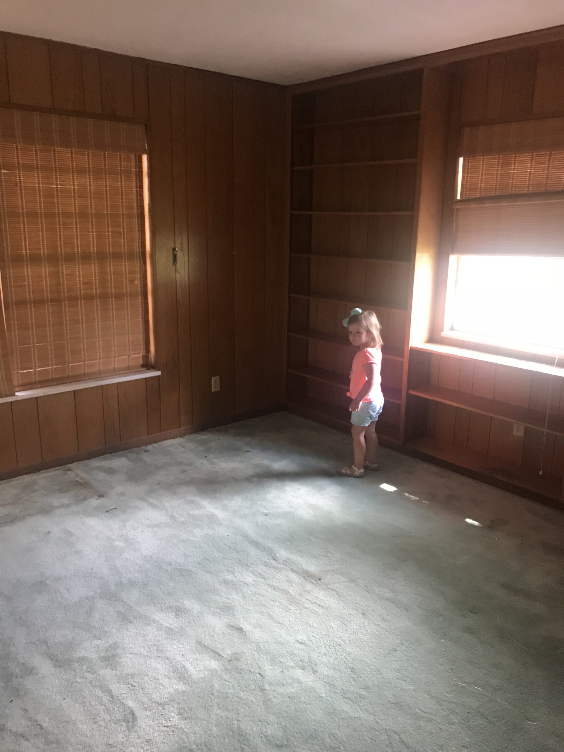 This is the current study that we are moving the master bedroom to. We are adding an additional window in this room to frame the bed in between along the wall Sutton is currently standing next to. Should we keep the wood paneling? Ok ok I’ll stop wi…