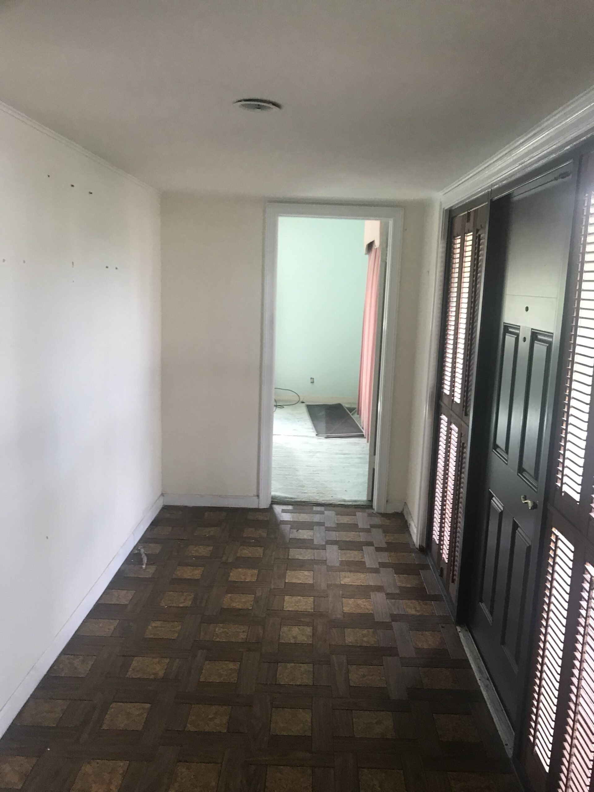 Looking to the right of the front door. This room is currently the master but will become an office. There will be French doors and I’m debating on leaving the pink curtains and green carpet...thoughts? ;)&nbsp;